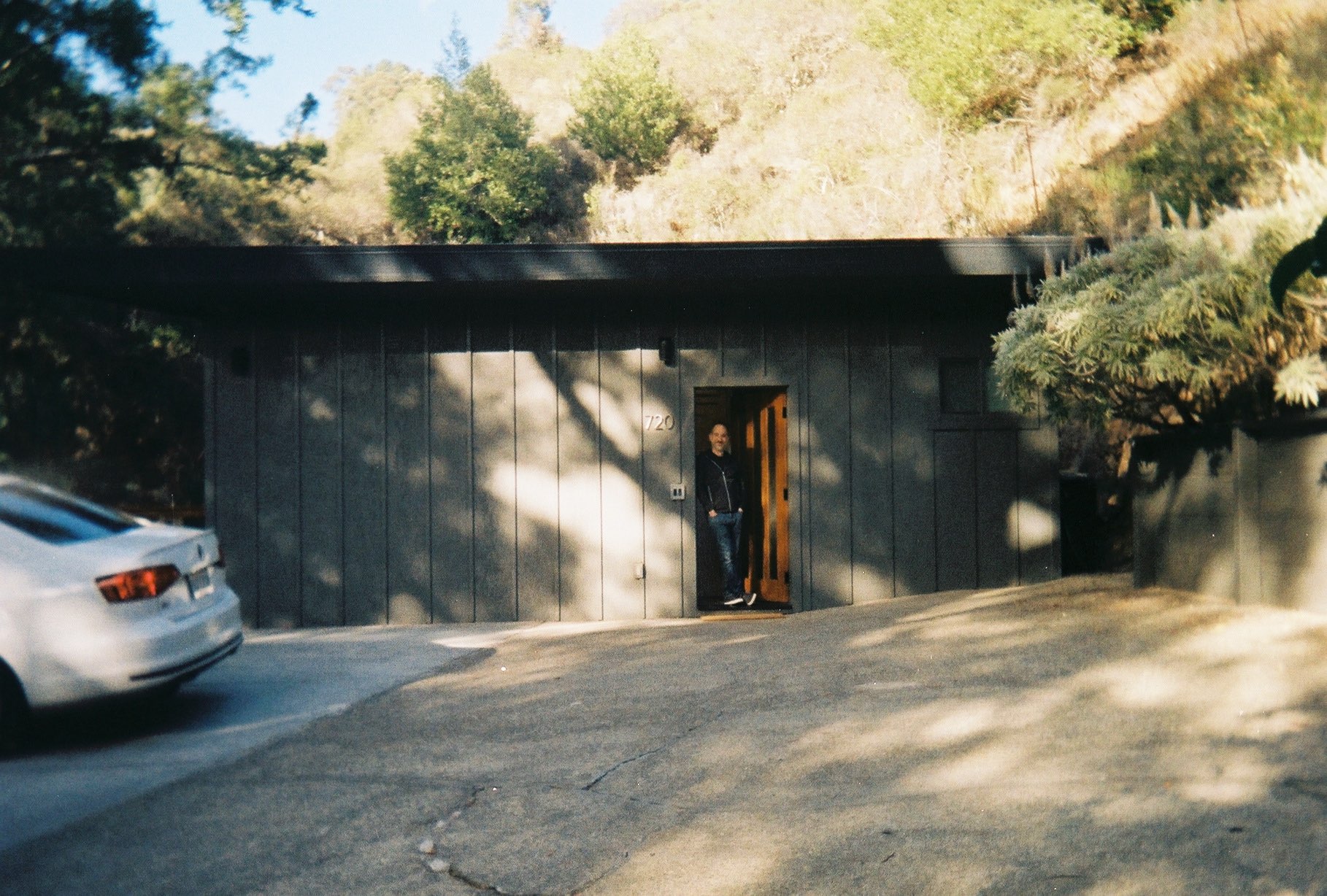 man stands in doorway of his home