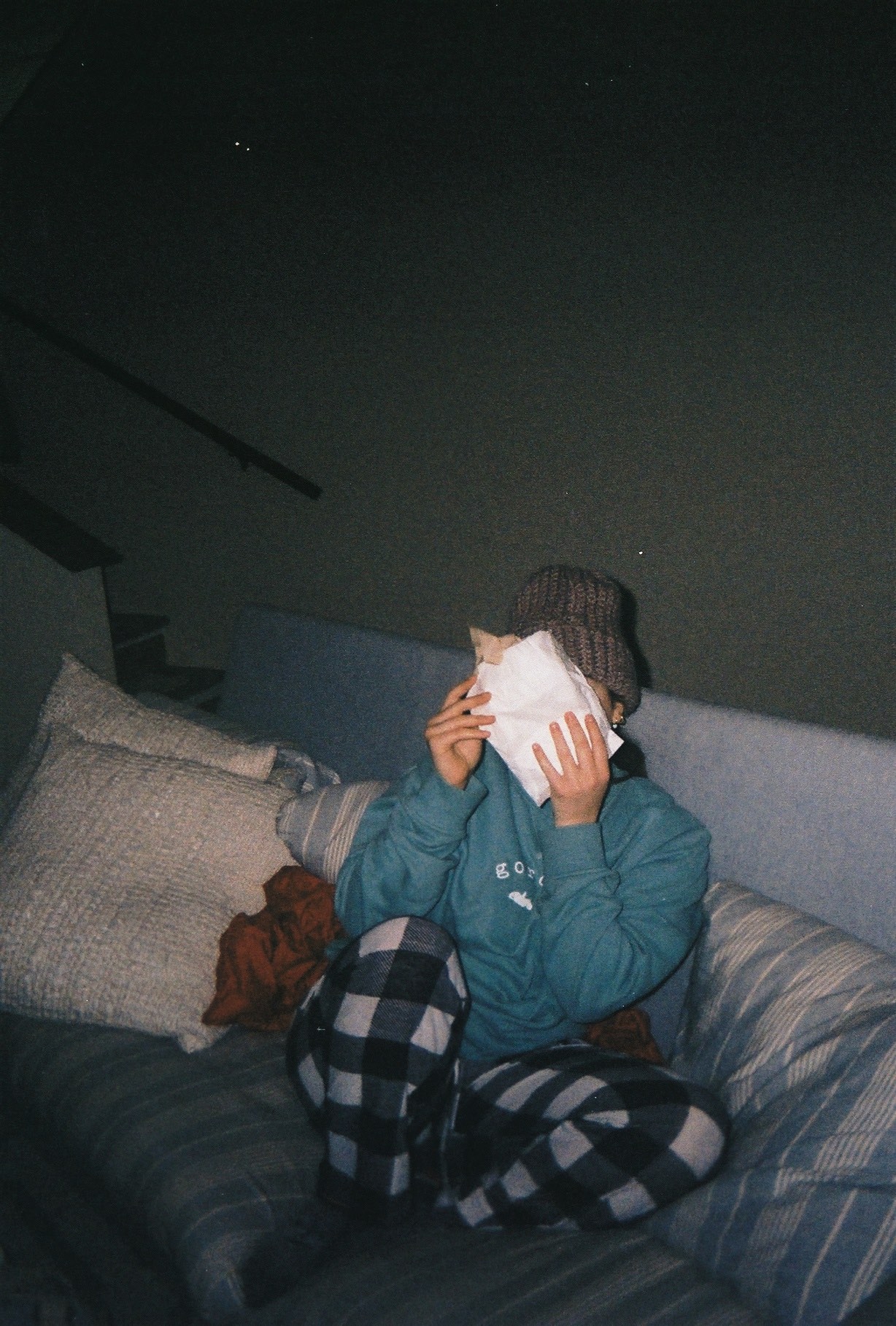 woman covers her face with a pastry wrapper