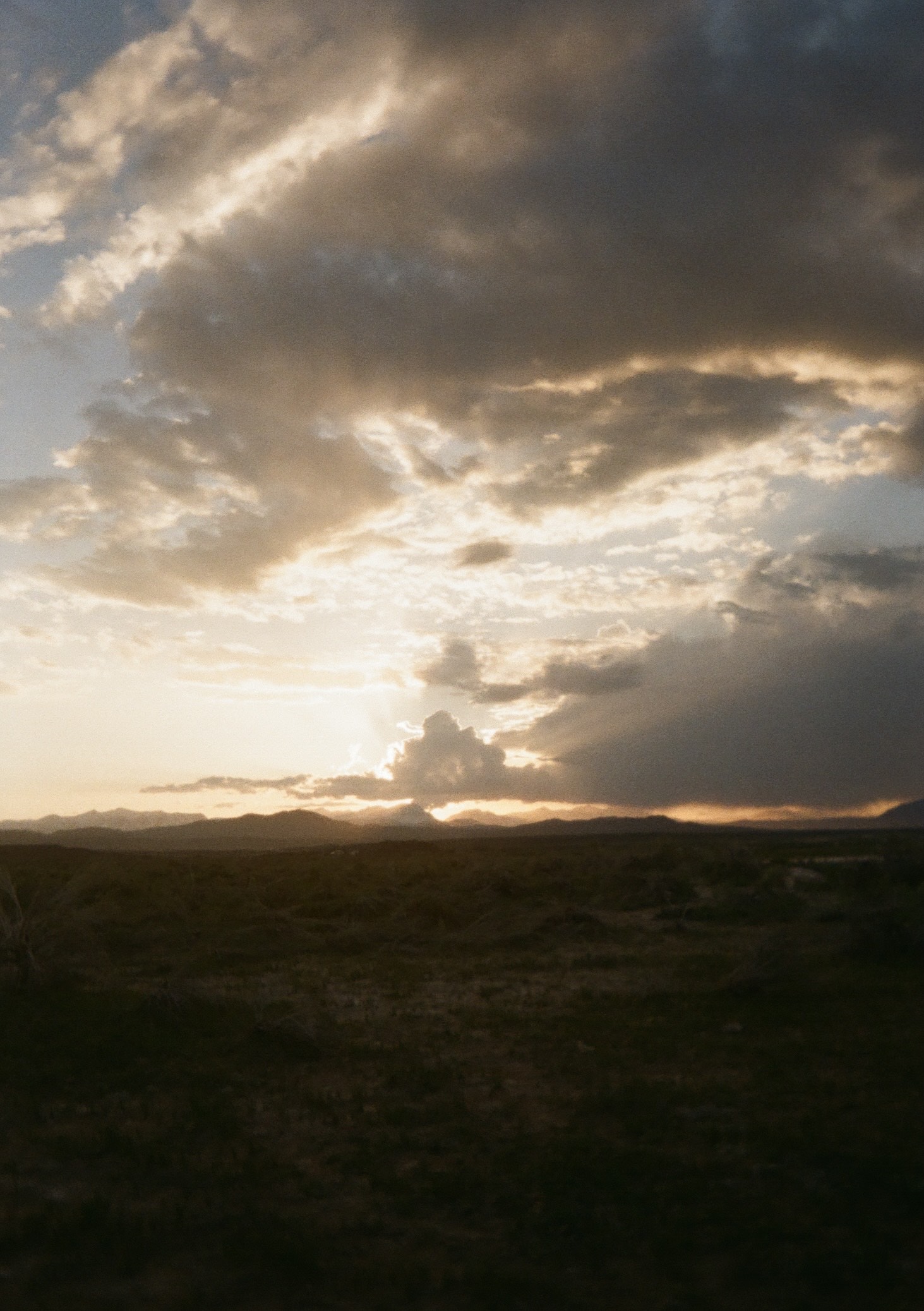 light peaks through clouds before sunset