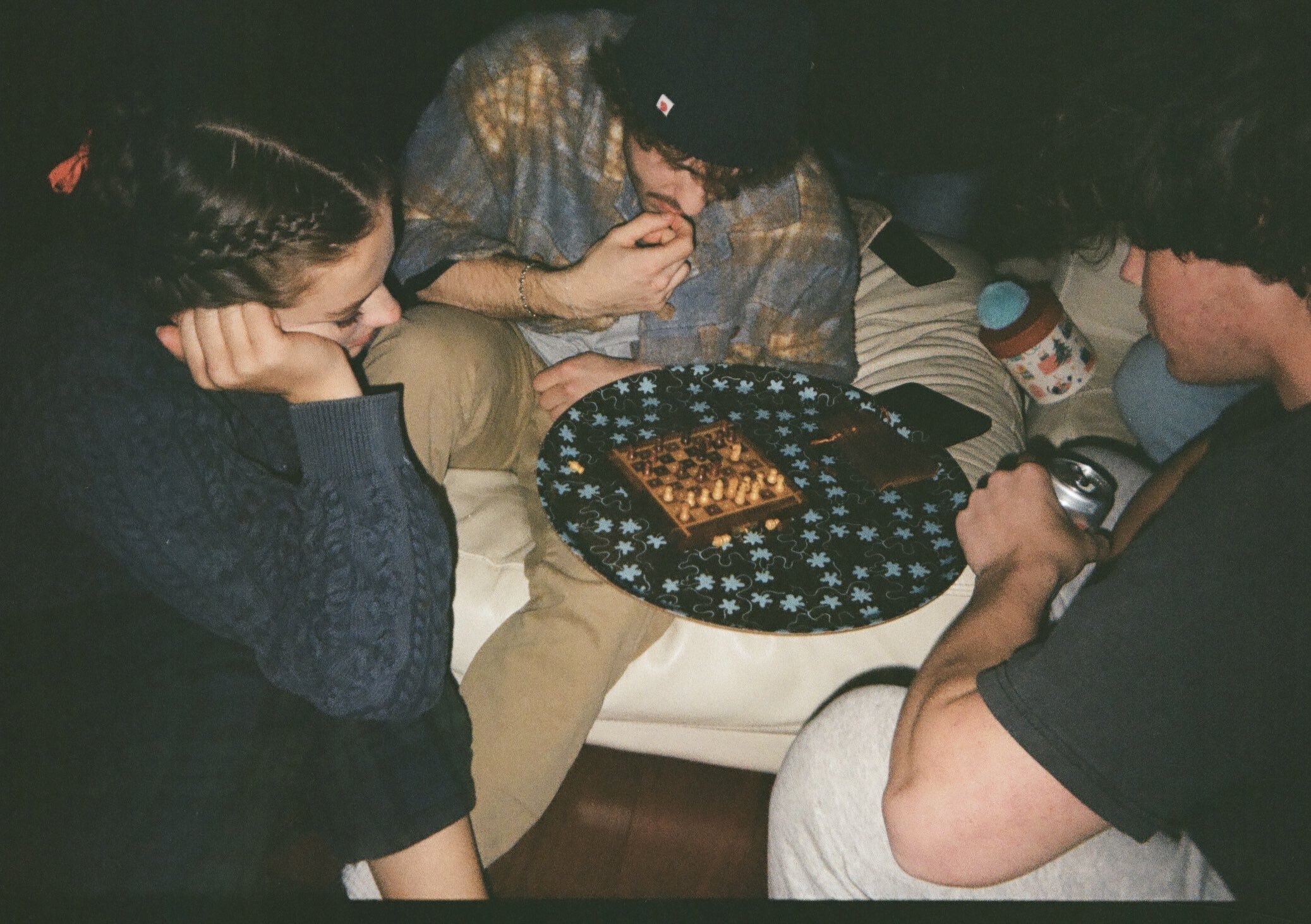 3 people ponder a chess game