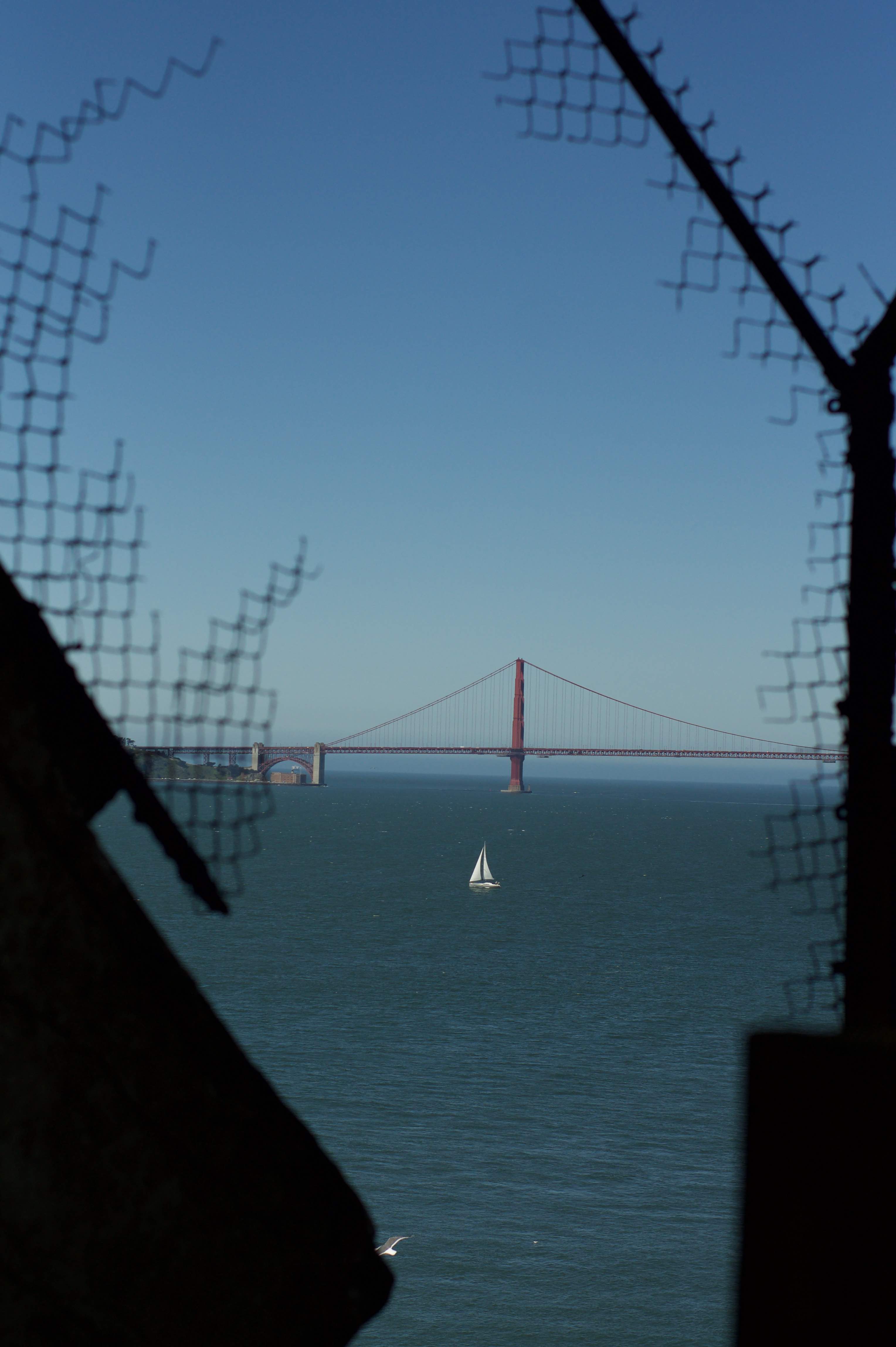 sailboat in front of the golden gate bridge