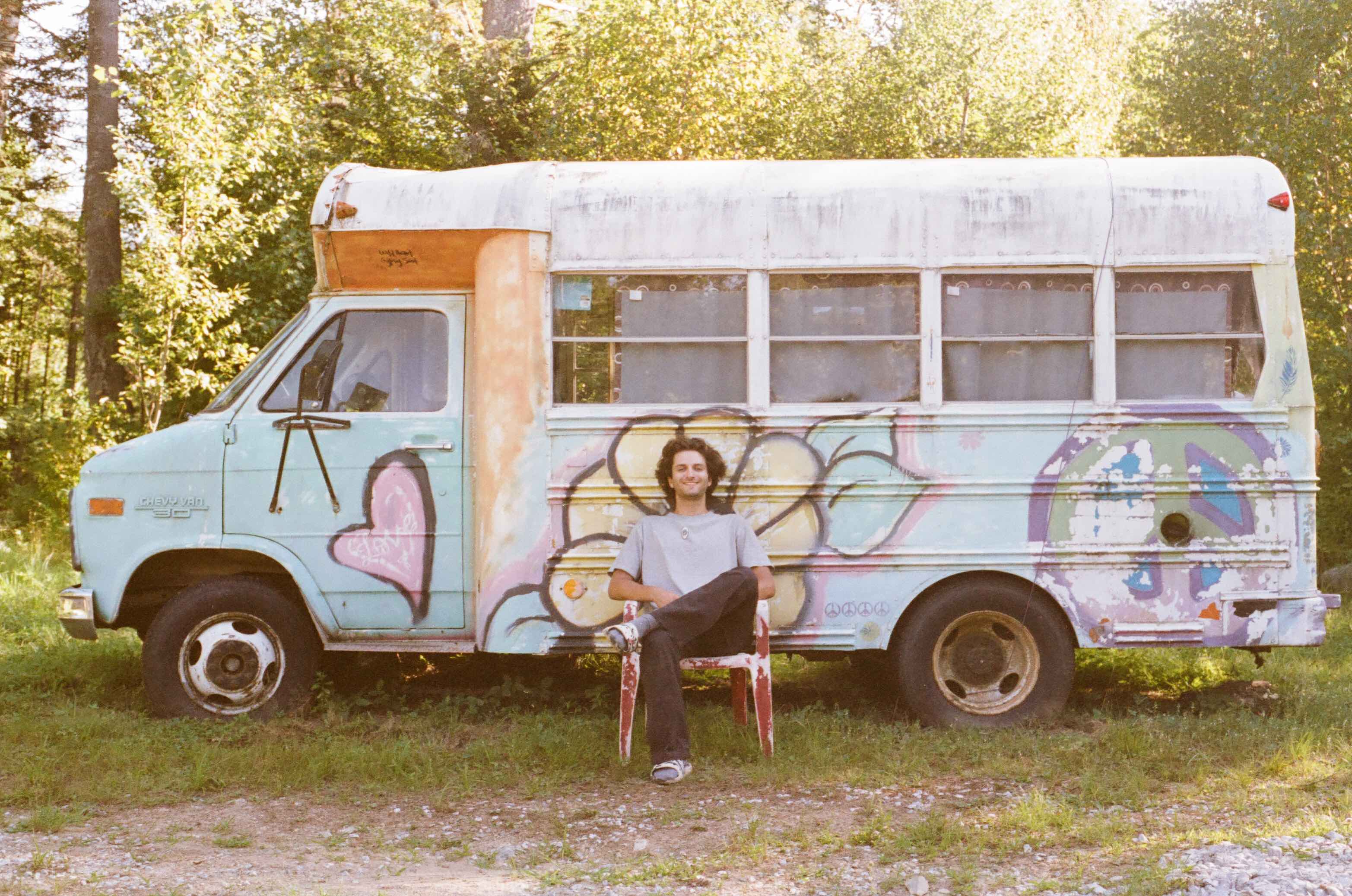 man sits in front of a bus