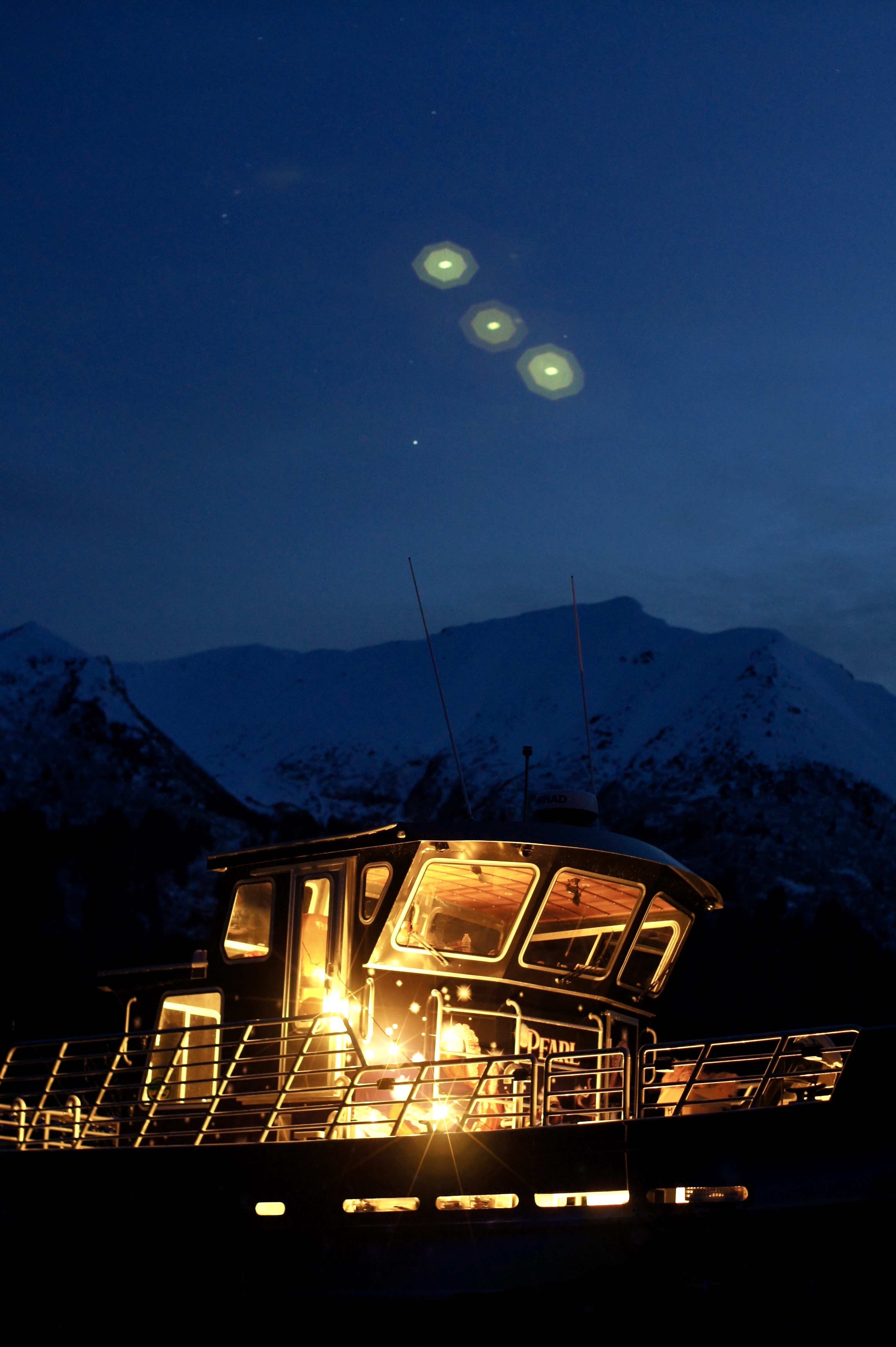 fishing boat pearl sits in front of snowy mountains