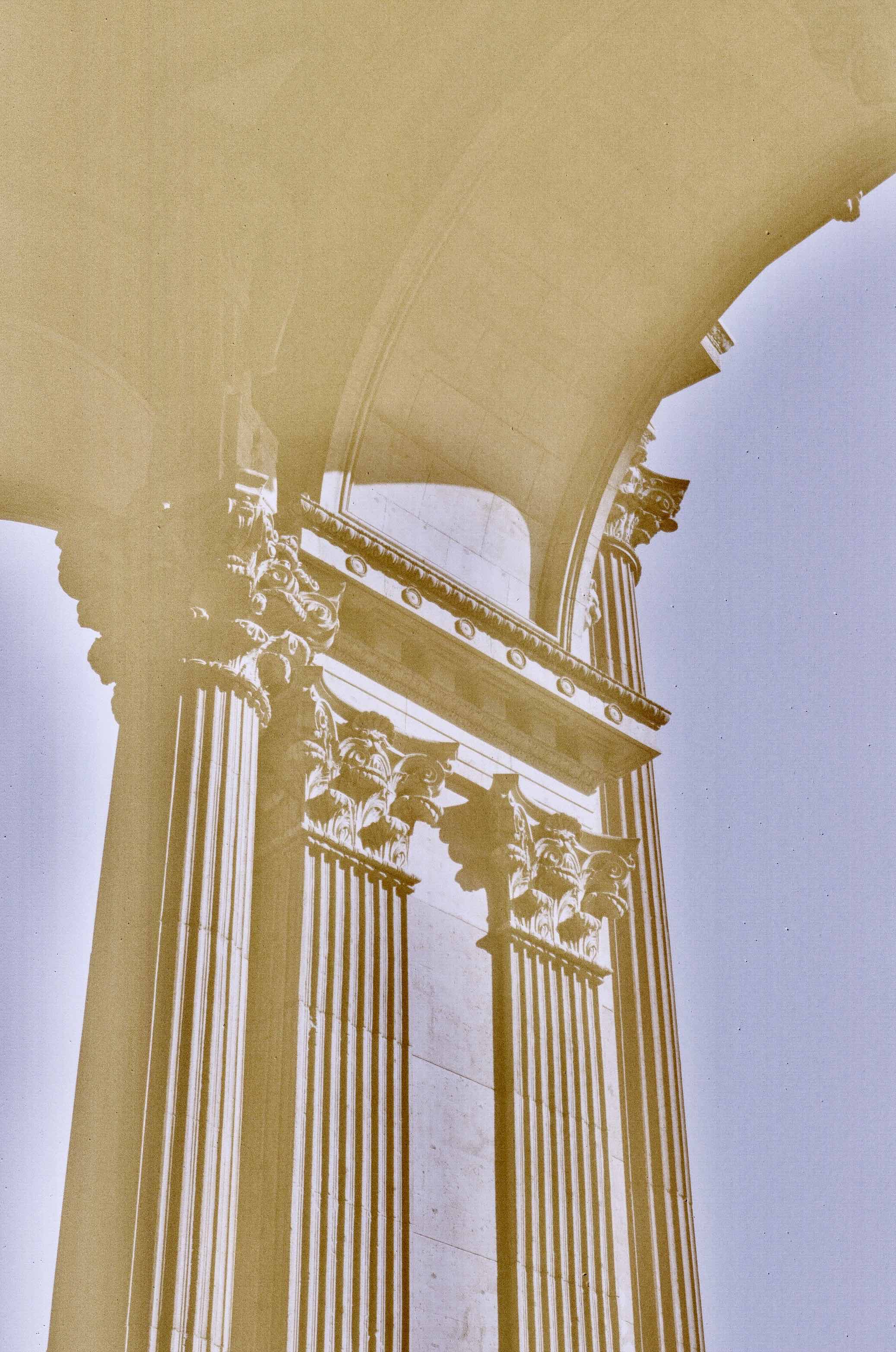 a tan and yellow photo under the palace of fine arts dome
