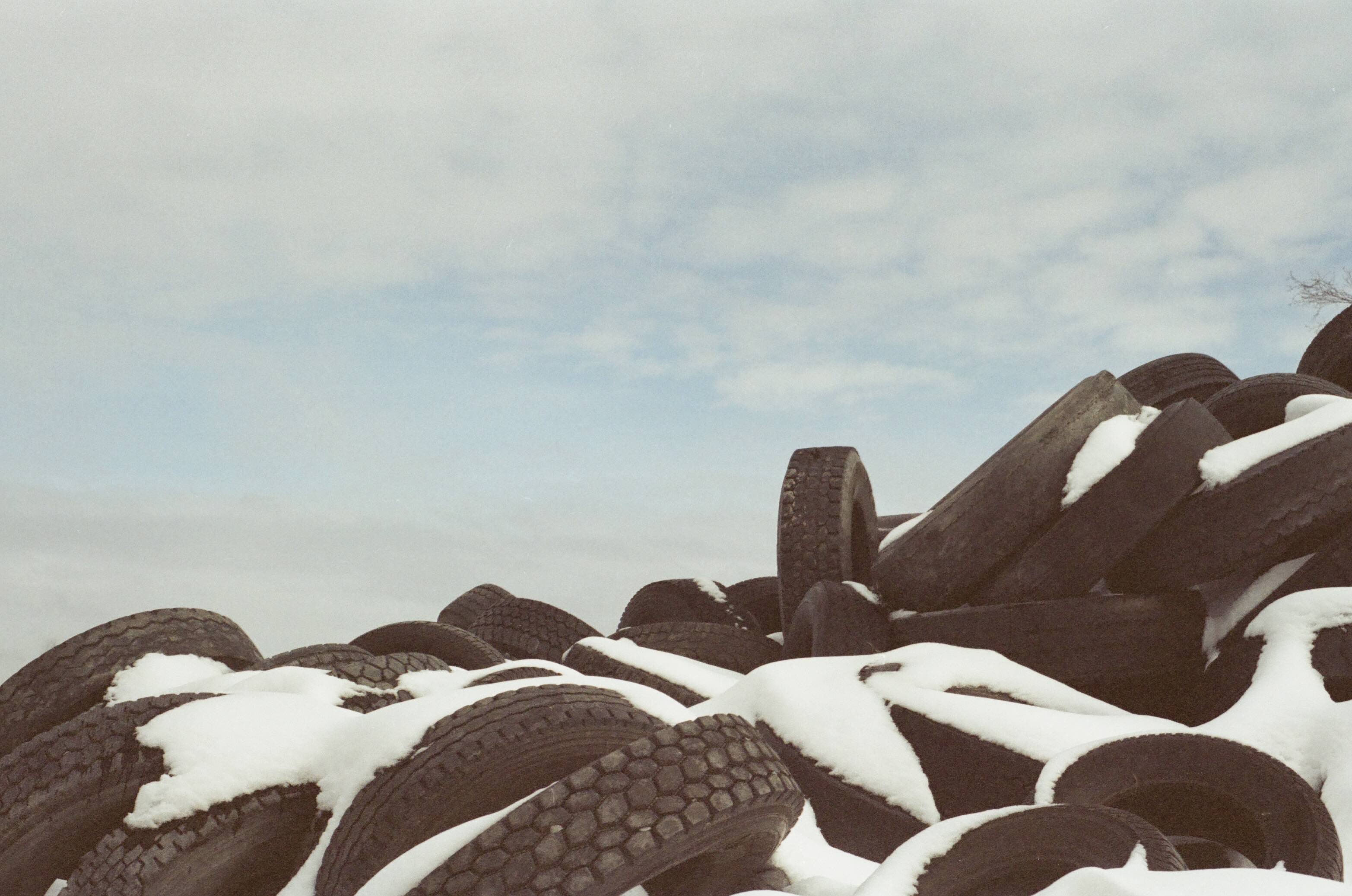 a pile of snow capped tires