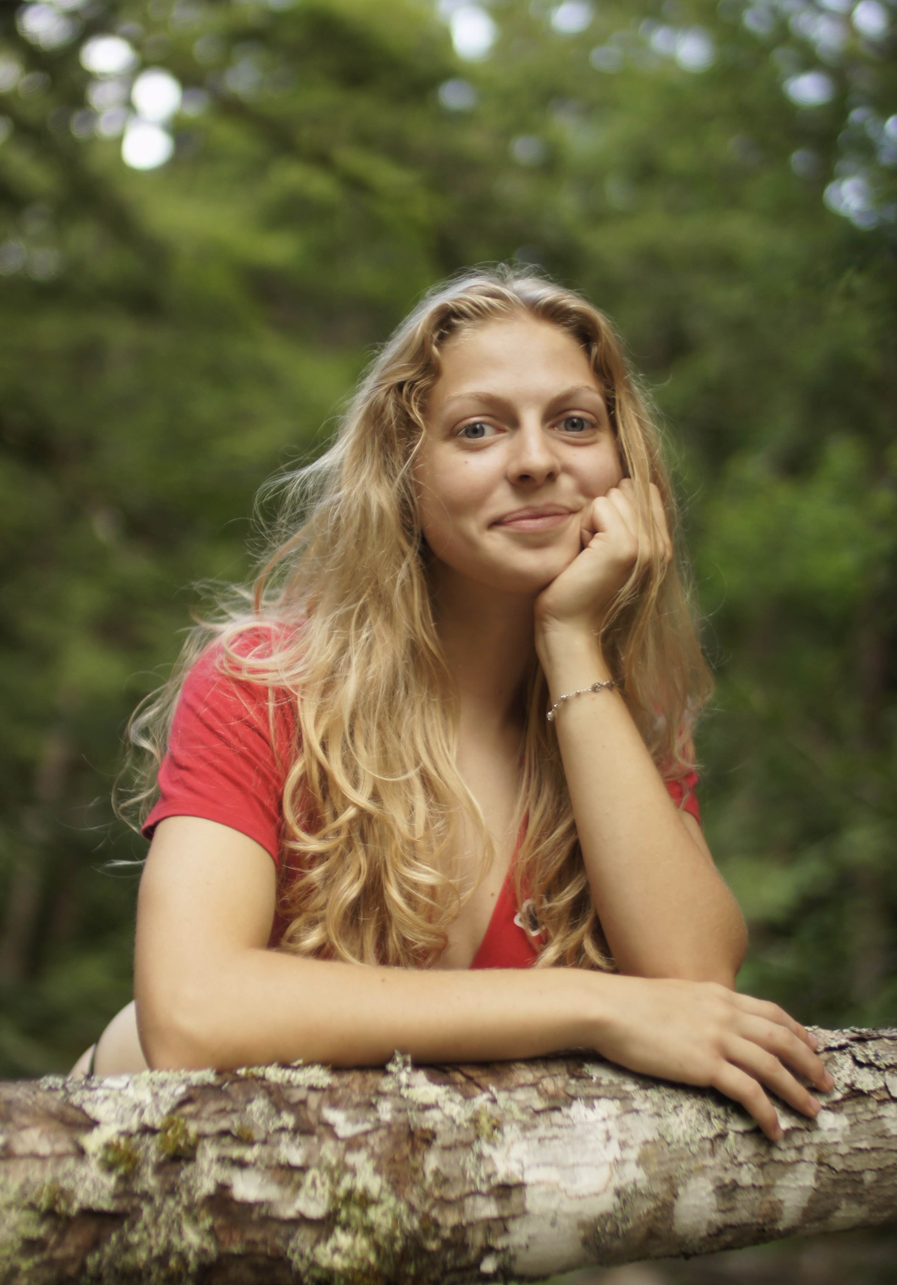 woman leaning on a log
