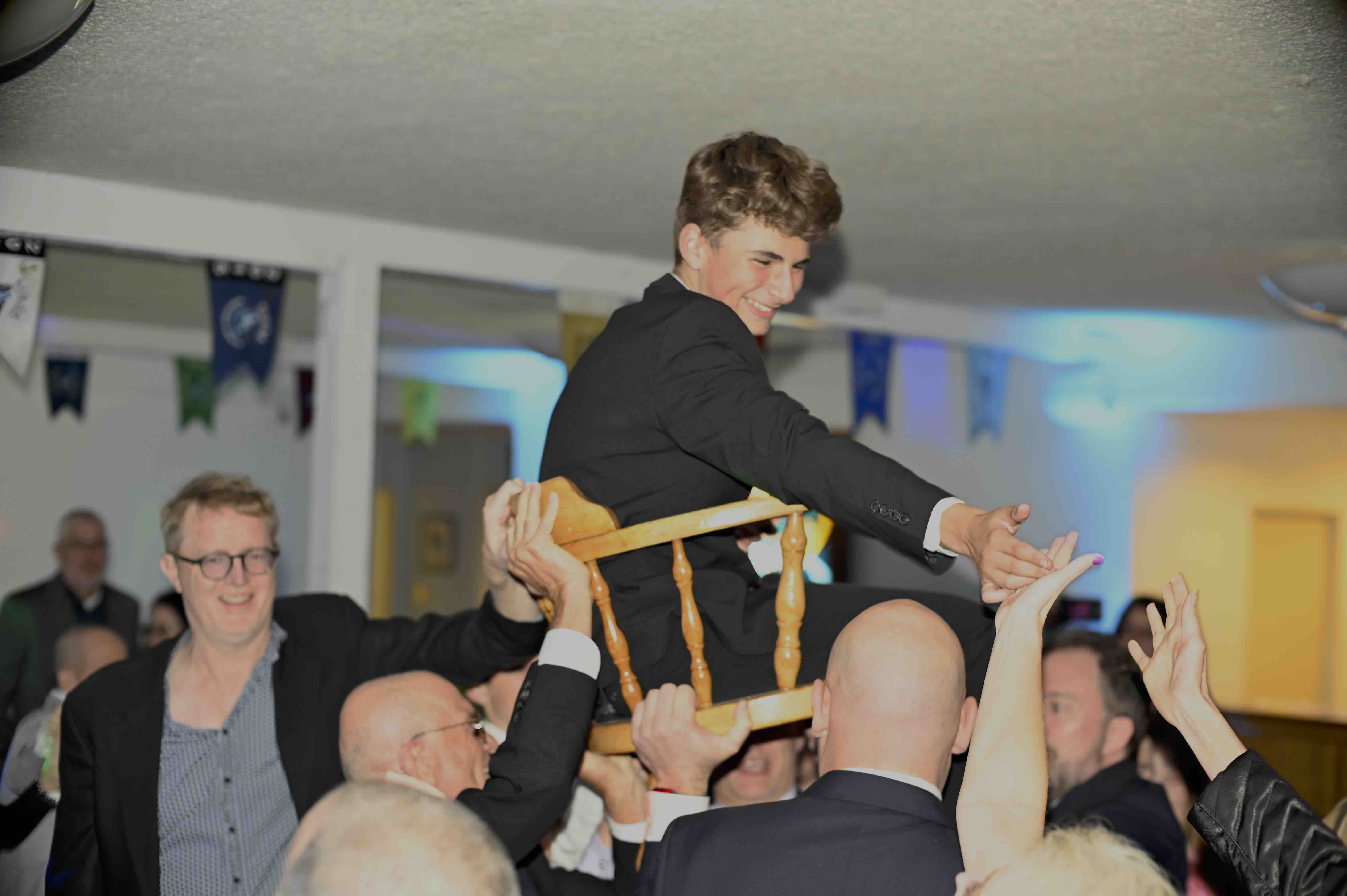 man smiles while in a hora