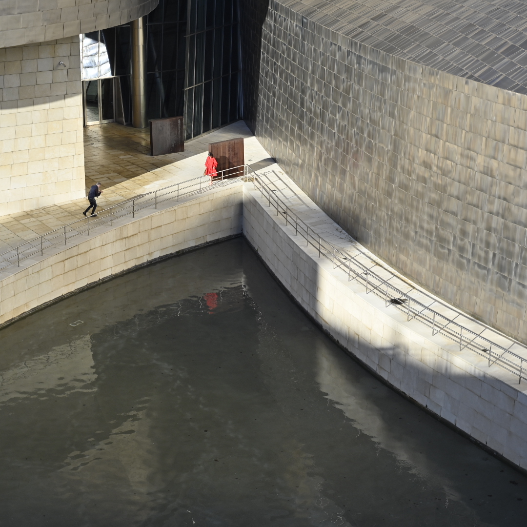Photographer takes a photo of a woman in a red dress